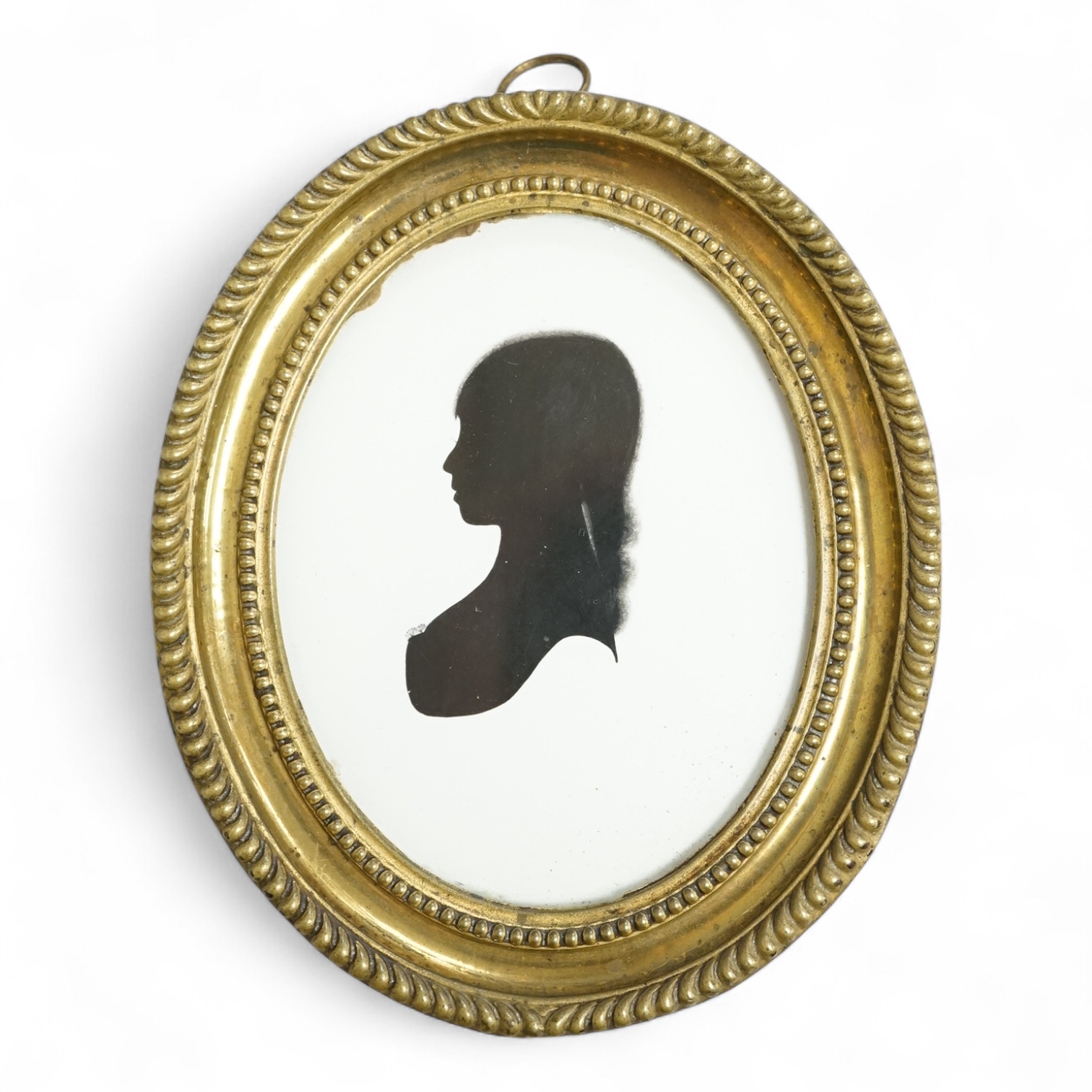 Mrs Mary Lightfoot (18th. C), oval painted silhouette portrait of a young lady, on plaster, printed trade label verso, embossed brass frame, overall 12cm high